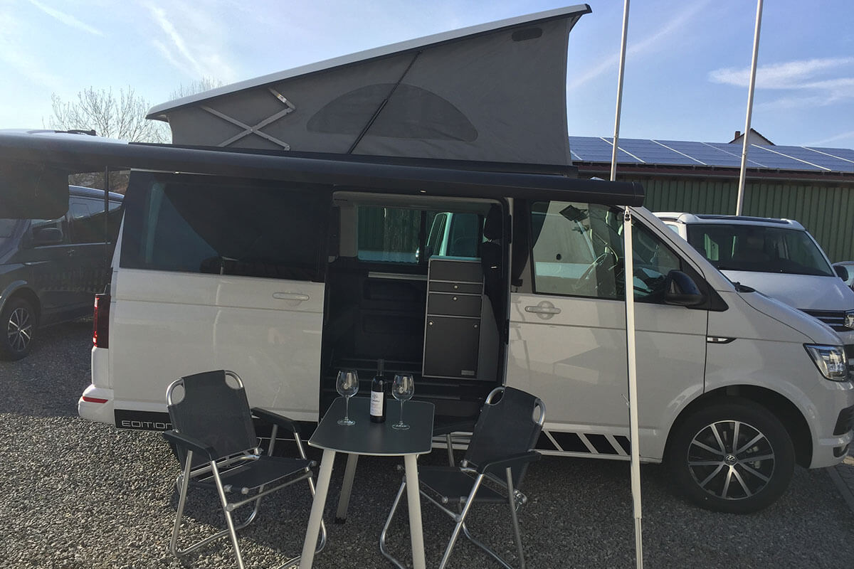 VW T6 California Beach mit Campingtisch und Stühlen